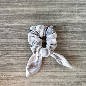 A Scrunchie - Gray & Taupe Abstract on a wooden table.