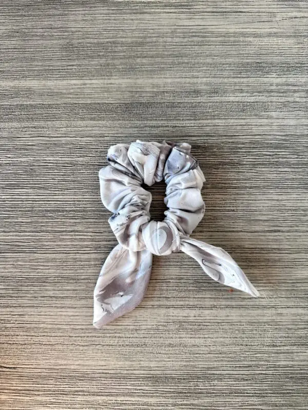 A Scrunchie - Gray & Taupe Abstract on a wooden table.