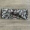 A leopard print headband is laying on the table.